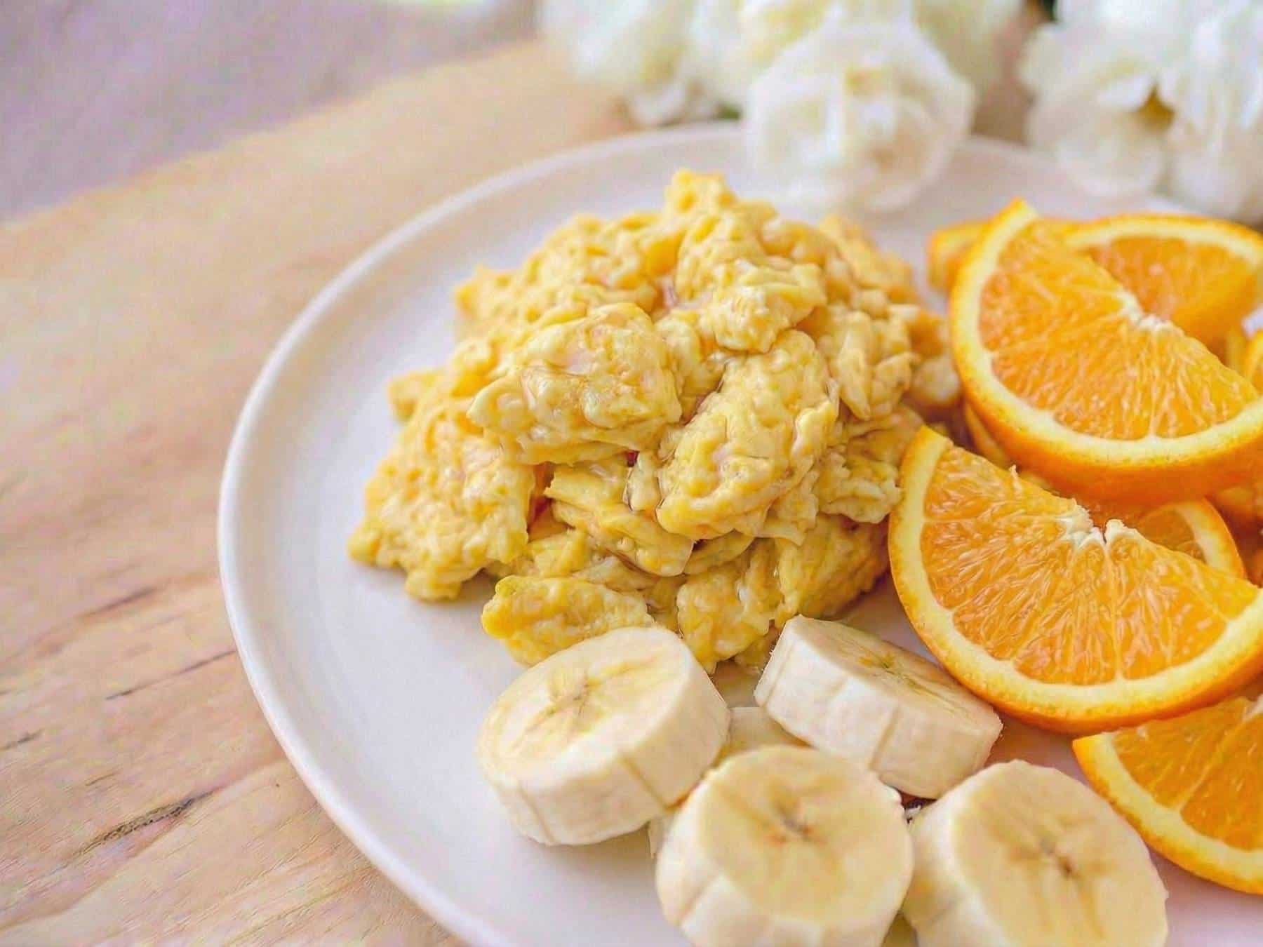 Pre-cooked scrambled eggs plated with fruit